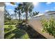 Landscaped backyard with lush greenery and privacy wall at 7561 Pesaro Dr, Sarasota, FL 34238