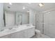 Bright bathroom boasts double sinks, a shower, and a toilet at 7561 Pesaro Dr, Sarasota, FL 34238