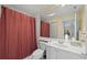 Clean bathroom with a toilet, sink, and shower/tub combo at 7561 Pesaro Dr, Sarasota, FL 34238