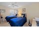 Guest bedroom with two twin beds, a desk, and ample natural light at 7561 Pesaro Dr, Sarasota, FL 34238