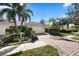 Single-story home with attached garage and landscaped yard at 7561 Pesaro Dr, Sarasota, FL 34238