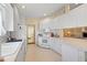 Well-equipped kitchen boasting white cabinetry and ample counter space at 7561 Pesaro Dr, Sarasota, FL 34238