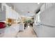 Modern kitchen with white cabinets, view into dining area at 7561 Pesaro Dr, Sarasota, FL 34238