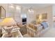 Bright living room featuring built-in shelving and a cozy atmosphere at 7561 Pesaro Dr, Sarasota, FL 34238