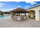 Relax and enjoy drinks at the tiki bar by the pool at 7561 Pesaro Dr, Sarasota, FL 34238