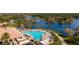 Resort-style pool and clubhouse with surrounding landscape at 7561 Pesaro Dr, Sarasota, FL 34238