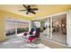 Bright screened porch overlooking backyard with view of kitchen at 7561 Pesaro Dr, Sarasota, FL 34238