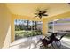 Relaxing screened porch with ceiling fan and view of backyard at 7561 Pesaro Dr, Sarasota, FL 34238