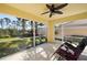 Relaxing screened porch with ceiling fan and patio furniture at 7561 Pesaro Dr, Sarasota, FL 34238