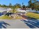 Single-wide manufactured home with carport and palm tree at 808 53Rd E Ave # 226L, Bradenton, FL 34203