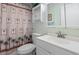 Clean bathroom with white vanity and palm-themed shower curtain at 808 53Rd E Ave # 226L, Bradenton, FL 34203