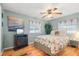 Comfortable bedroom with a palm-print bedspread and a TV at 808 53Rd E Ave # 226L, Bradenton, FL 34203