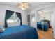 Guest bedroom with a blue bedspread and mirrored closet doors at 808 53Rd E Ave # L 226, Bradenton, FL 34203