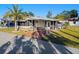 Single-wide manufactured home with carport and palm trees at 808 53Rd E Ave # 226L, Bradenton, FL 34203