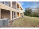 Ground level view of building exterior and grassy area at 8908 White Sage Loop, Lakewood Ranch, FL 34202