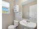 Clean bathroom with toilet, sink, and mirror at 8908 White Sage Loop, Lakewood Ranch, FL 34202
