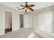 Bright bedroom with ceiling fan and access to bathroom and hallway at 8908 White Sage Loop, Lakewood Ranch, FL 34202