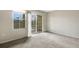 Bright bedroom with carpet flooring and access to a balcony at 8908 White Sage Loop, Lakewood Ranch, FL 34202