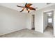 Bedroom with ceiling fan, access to bathroom and hallway at 8908 White Sage Loop, Lakewood Ranch, FL 34202