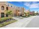 Townhome community with sidewalk, street, and lush landscaping at 8908 White Sage Loop, Lakewood Ranch, FL 34202