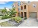 Tan three-story townhome with attached garage and landscaping at 8908 White Sage Loop, Lakewood Ranch, FL 34202