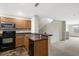 Kitchen features wood cabinets, dark countertops, and stainless steel appliances at 8908 White Sage Loop, Lakewood Ranch, FL 34202