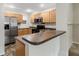 Kitchen boasts stainless steel appliances and wood cabinets at 8908 White Sage Loop, Lakewood Ranch, FL 34202
