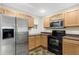 Stainless steel appliances and light wood cabinets in this kitchen at 8908 White Sage Loop, Lakewood Ranch, FL 34202