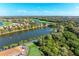 Aerial view of the community, showcasing homes and a lake at 9711 Sea Turtle Ter # 102, Bradenton, FL 34212
