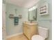 Light and bright bathroom with beige vanity and granite countertop at 9711 Sea Turtle Ter # 102, Bradenton, FL 34212