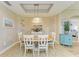 Charming dining room with an oval table and six chairs, stylish light fixture at 9711 Sea Turtle Ter # 102, Bradenton, FL 34212
