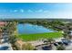 Aerial view of a driving range with a lake and houses at 9711 Sea Turtle Ter # 102, Bradenton, FL 34212