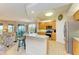 Open concept kitchen with island, stainless steel appliances, and view of living room at 9711 Sea Turtle Ter # 102, Bradenton, FL 34212