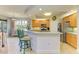 Modern kitchen with light wood cabinets, stainless steel appliances and breakfast bar at 9711 Sea Turtle Ter # 102, Bradenton, FL 34212