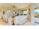 Bright living room with comfy seating, large windows, and access to a relaxing patio at 9711 Sea Turtle Ter # 102, Bradenton, FL 34212