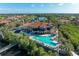 Resort-style pool and clubhouse with a relaxing waterfront view at 9711 Sea Turtle Ter # 102, Bradenton, FL 34212