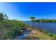 Peaceful riverfront view with lush greenery and palm trees at 9711 Sea Turtle Ter # 102, Bradenton, FL 34212