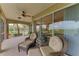 Spacious screened porch with wicker furniture at 9711 Sea Turtle Ter # 102, Bradenton, FL 34212