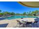 Inviting community pool with lounge chairs and tables at 9711 Sea Turtle Ter # 102, Bradenton, FL 34212