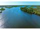Aerial view of a wide waterway with lush greenery at 9711 Sea Turtle Ter # 102, Bradenton, FL 34212