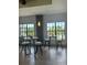 Community room with tables and chairs by the window at 1030 Tidewater Shores Loop # 306, Bradenton, FL 34208