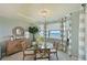 Bright dining room with bay window, glass table, and four chairs. Water views at 1030 Tidewater Shores Loop # 306, Bradenton, FL 34208