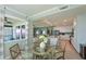 Dining area with glass table and kitchen view. Water views from window at 1030 Tidewater Shores Loop # 306, Bradenton, FL 34208