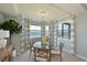 Bright dining room with bay window offering water views, glass table, and four chairs at 1030 Tidewater Shores Loop # 306, Bradenton, FL 34208