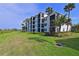 Condo building with palm trees and a grassy lawn at 1030 Tidewater Shores Loop # 306, Bradenton, FL 34208
