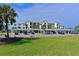Condo building exterior showcasing covered parking and landscaping at 1030 Tidewater Shores Loop # 306, Bradenton, FL 34208