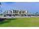 Building exterior with covered parking and lush green lawn at 1030 Tidewater Shores Loop # 306, Bradenton, FL 34208