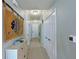 Hallway with light walls, unique wall hanging and carpeting at 1030 Tidewater Shores Loop # 306, Bradenton, FL 34208