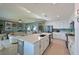 Open concept kitchen with island, stainless steel appliances, and adjacent living area at 1030 Tidewater Shores Loop # 306, Bradenton, FL 34208