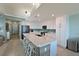 Modern kitchen with white cabinets, large island, and waterfront view at 1030 Tidewater Shores Loop # 306, Bradenton, FL 34208